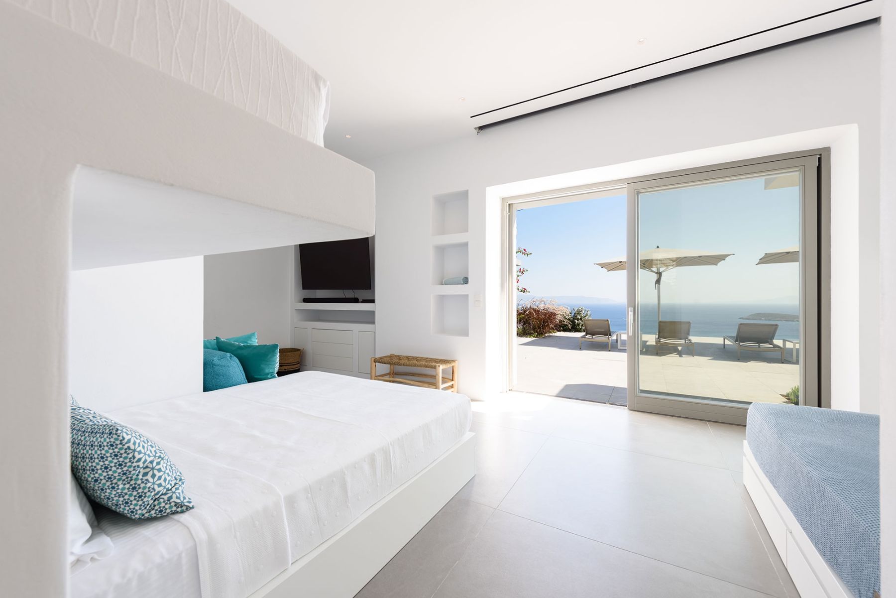 The bunk-room, feature an ensuite bathroom. and direct access to the terrace.