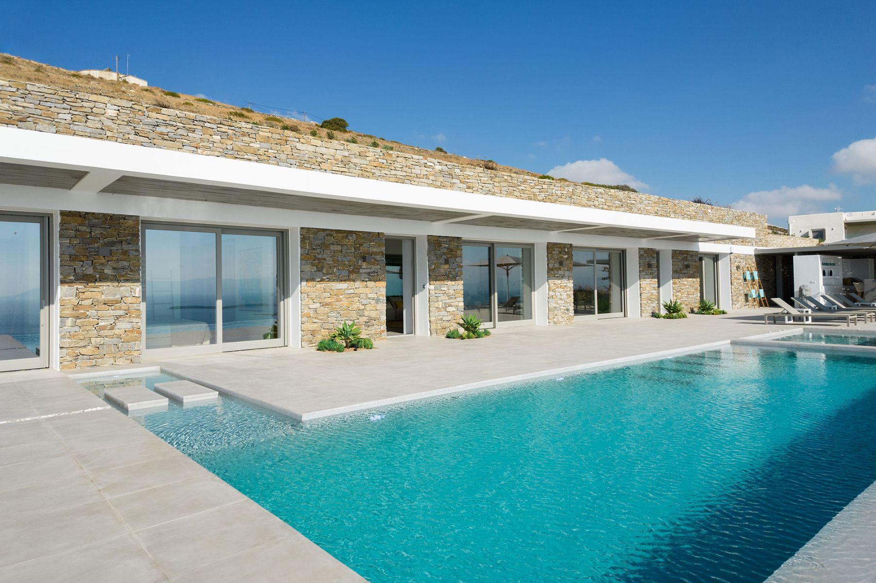 Contemporary minimal design in a one-level villa creates the ultimate summer feeling with private pool and sweeping sea views.