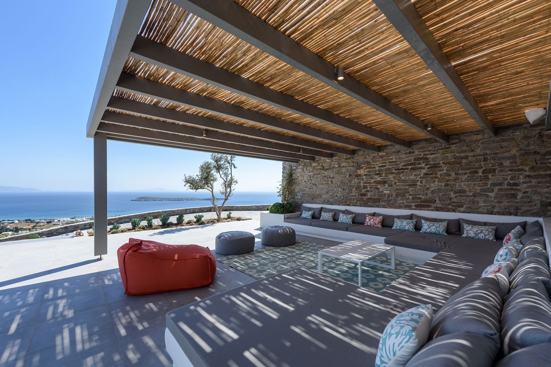 Large built-in sofas covered by coloured cushions and soft pillows offer all-day relaxation and recreation.
