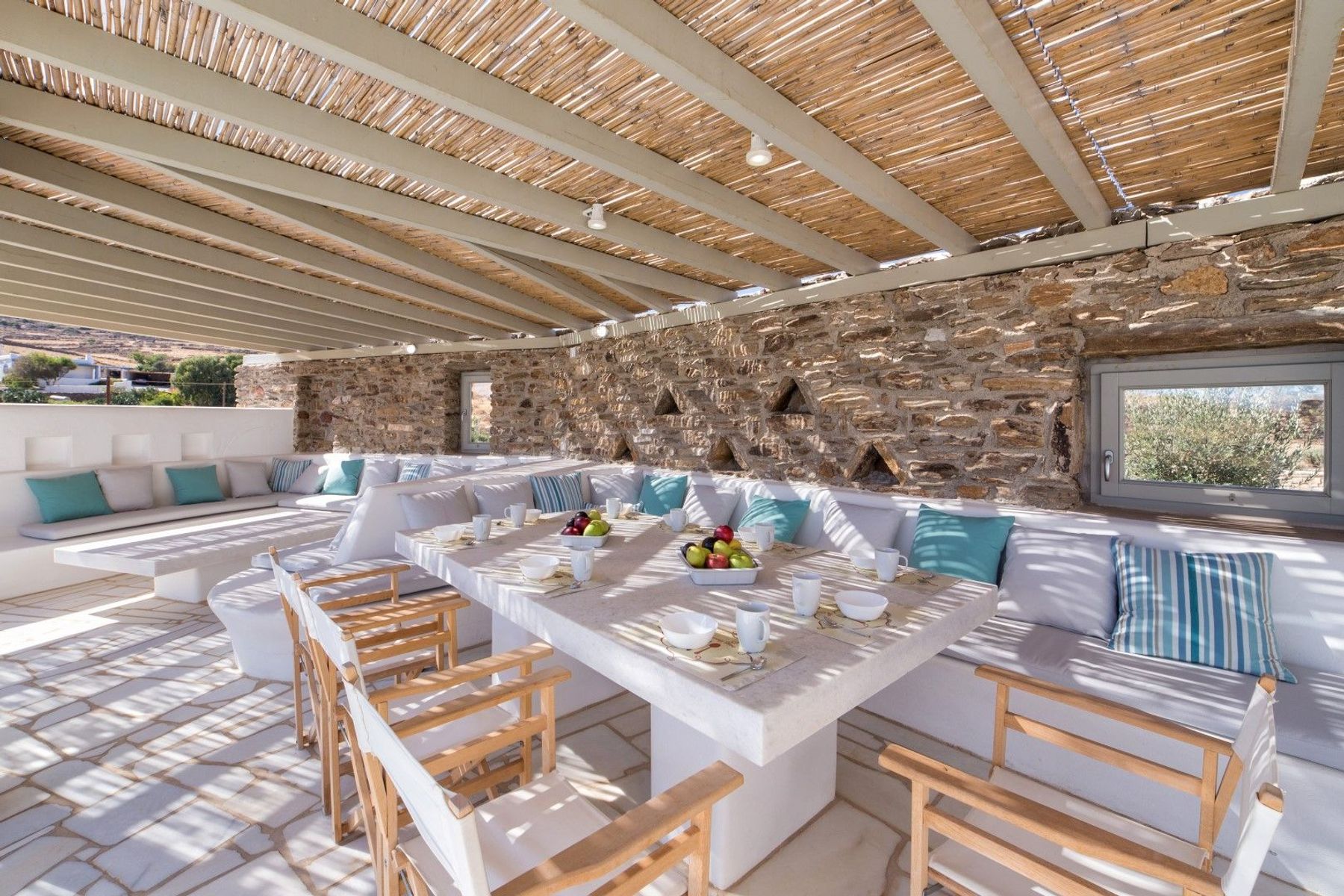 Pergola covered outdoor lounge and dining area, with seating for ten guests.