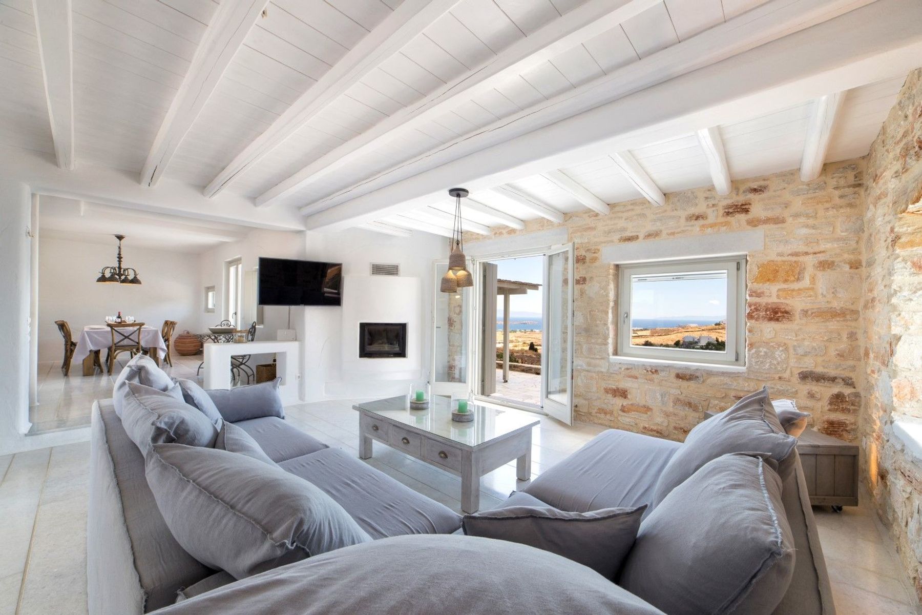 Modern open-plan living with bright and airy living space with sea views.

