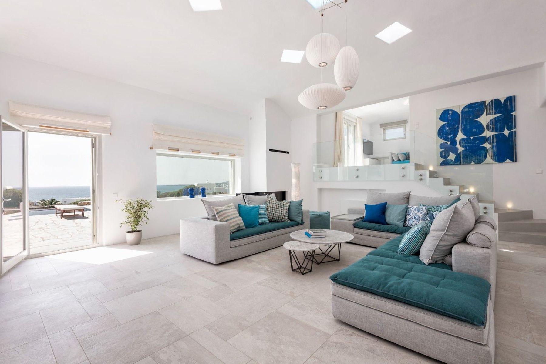 Modern, bright and airy lounge area, with doors leading to the terrace.