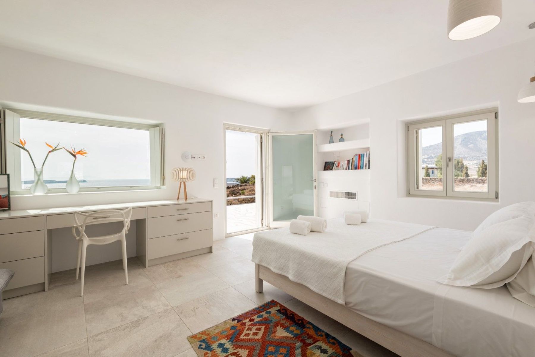 Double ensuite bedroom with an office desk and direct access to the pool terrace. 
