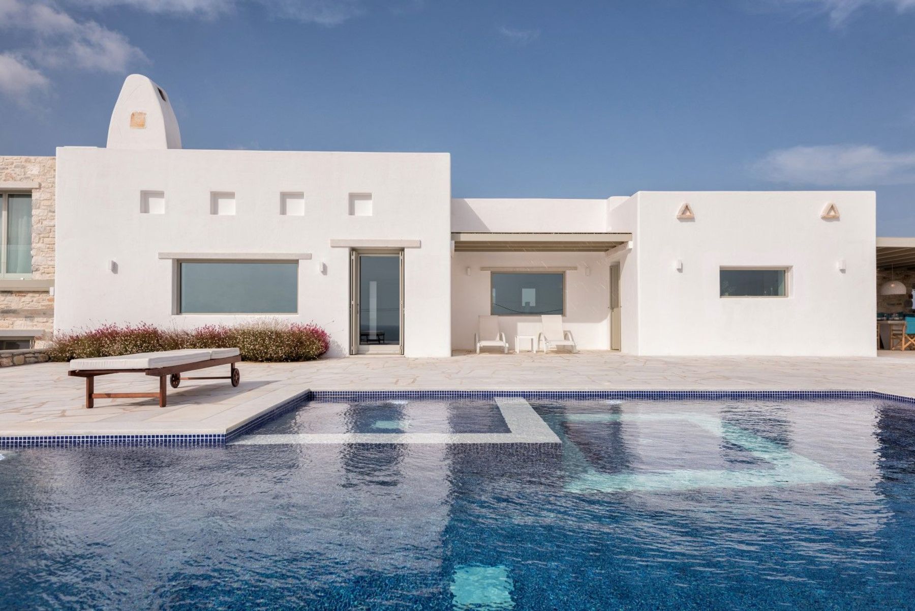 An exclusive 4-bedroom-plus-mezzanine luxury villa situated in the Golden Beach area of Paros.