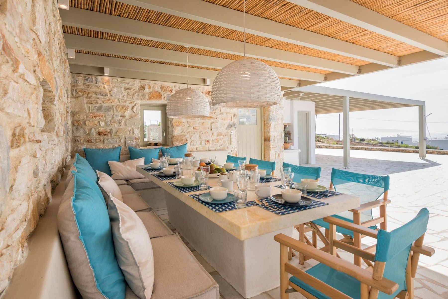 Dine alfresco with stunning sea views with table and seating for ten guests.
