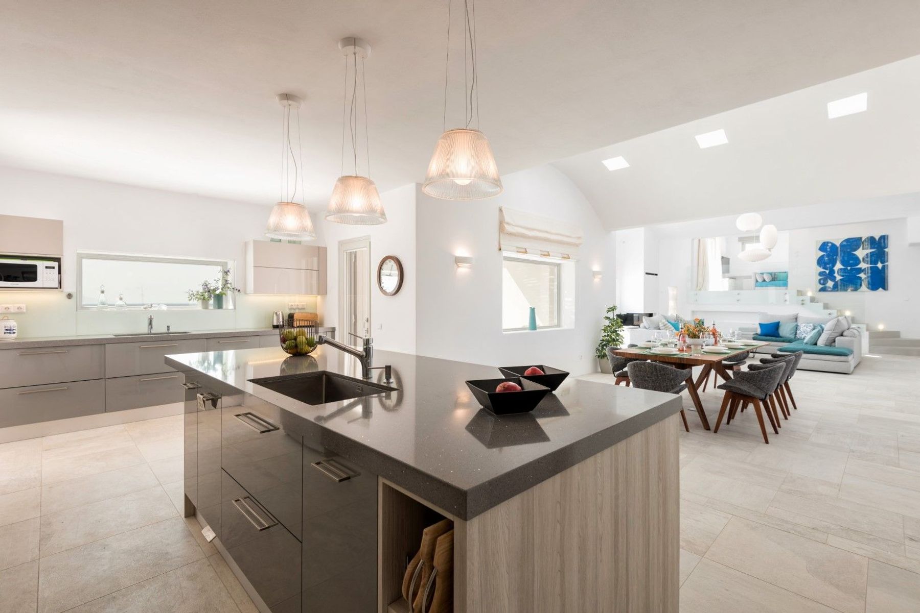Large modern and fully-equipped kitchen with central island.