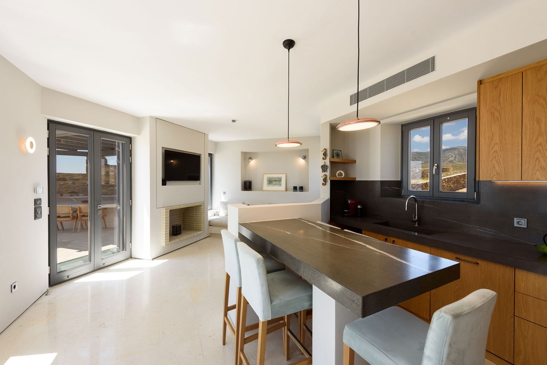 Modern kitchen with breakfast bar, with seating for three guests.