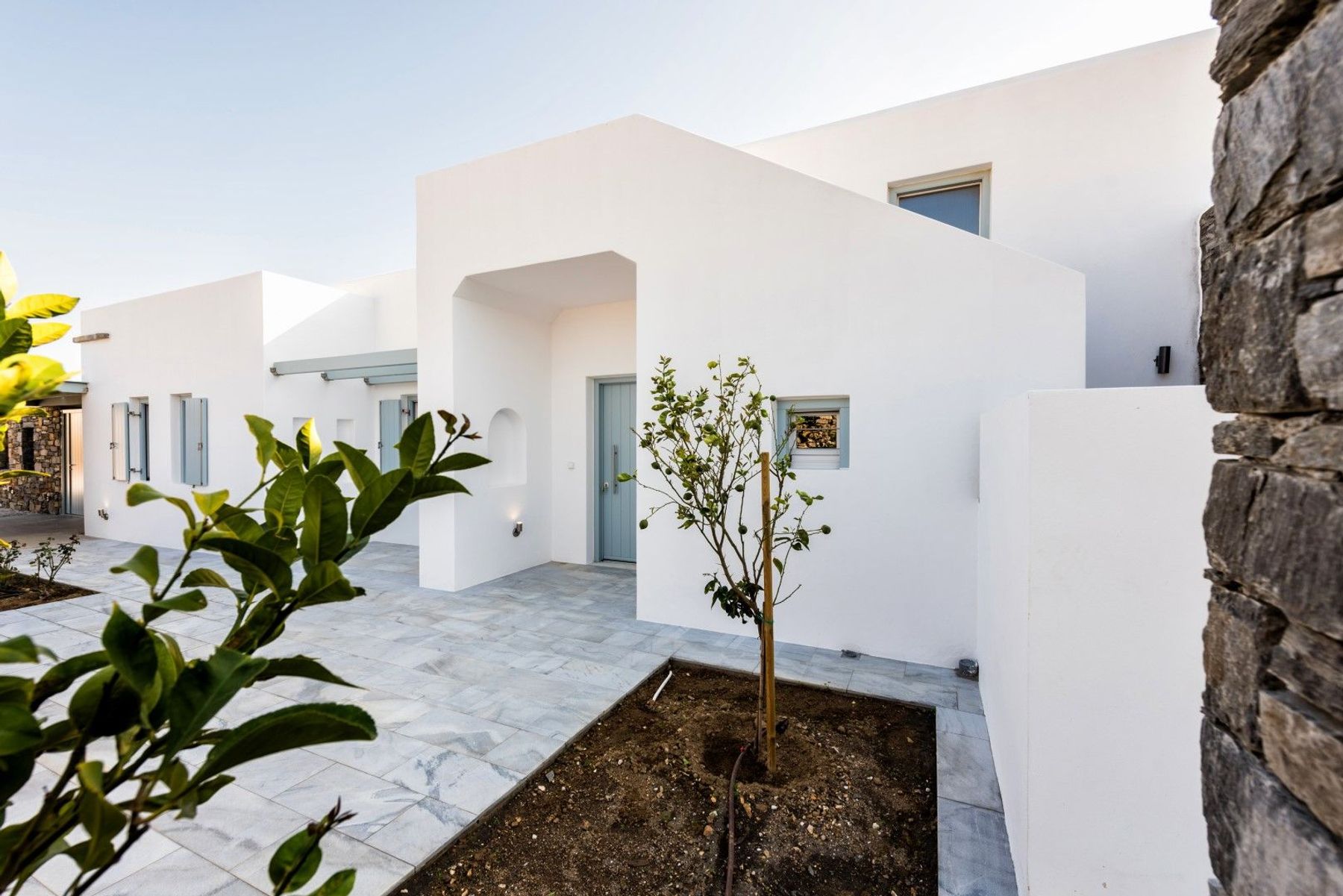 Greeneries around the patios complete the garden of this luxurious property.