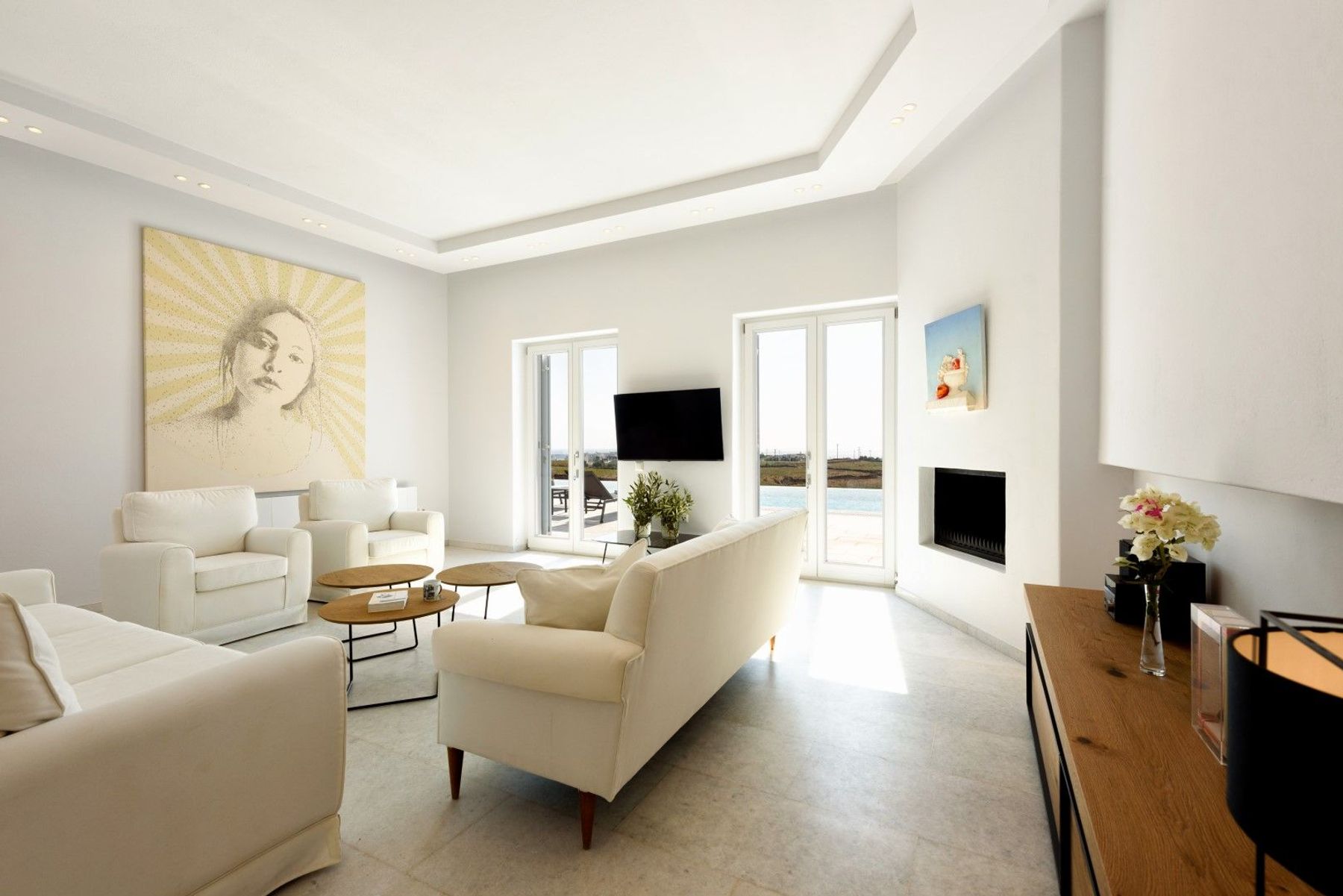Comfortable white sofas fill the living room area where the direct view to the sea.