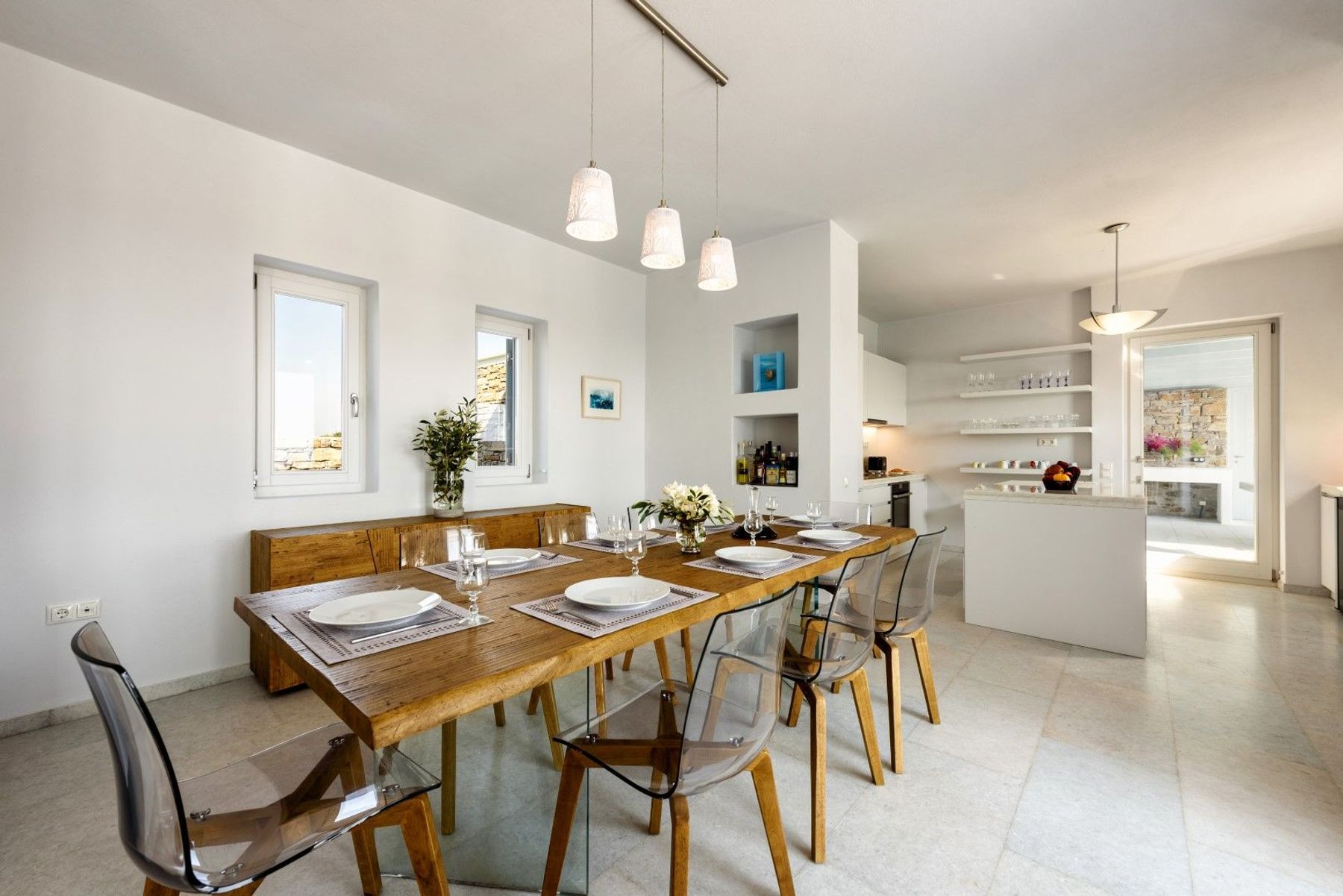 Open-plan kitchen and dining space, with table seating eight guests.