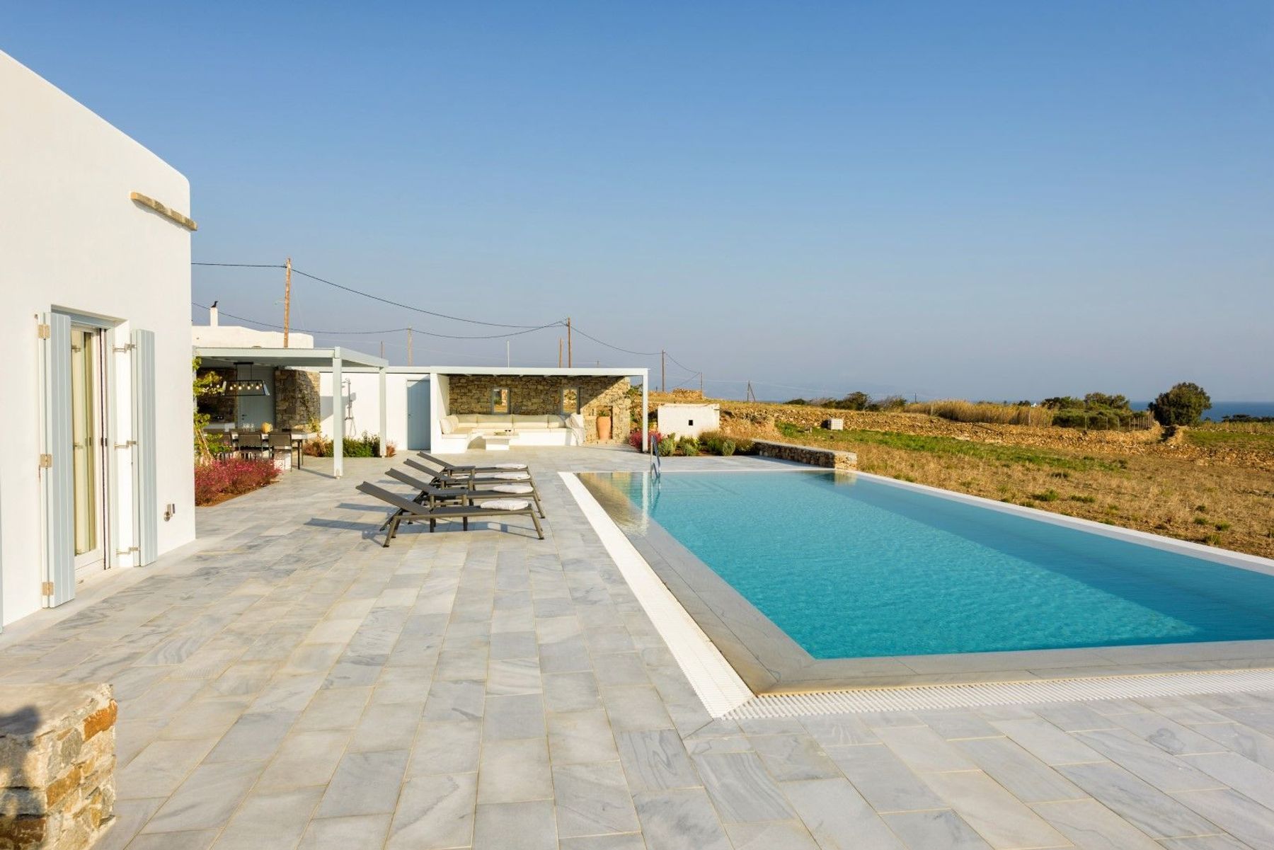 Spacious outside spaces have direct access from different indoor points, leading to the swimming pool.