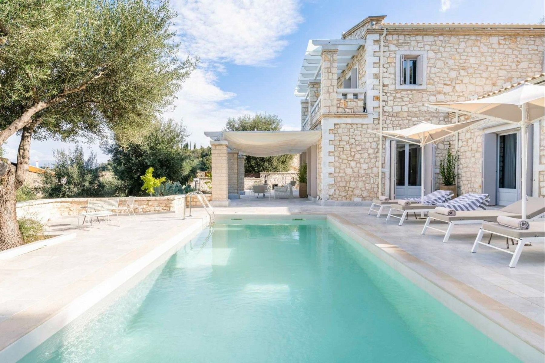 The estate boasts two private swimming pools, flanked with sun loungers, and parasols. The perfect spot to relax in the sunshine. 
