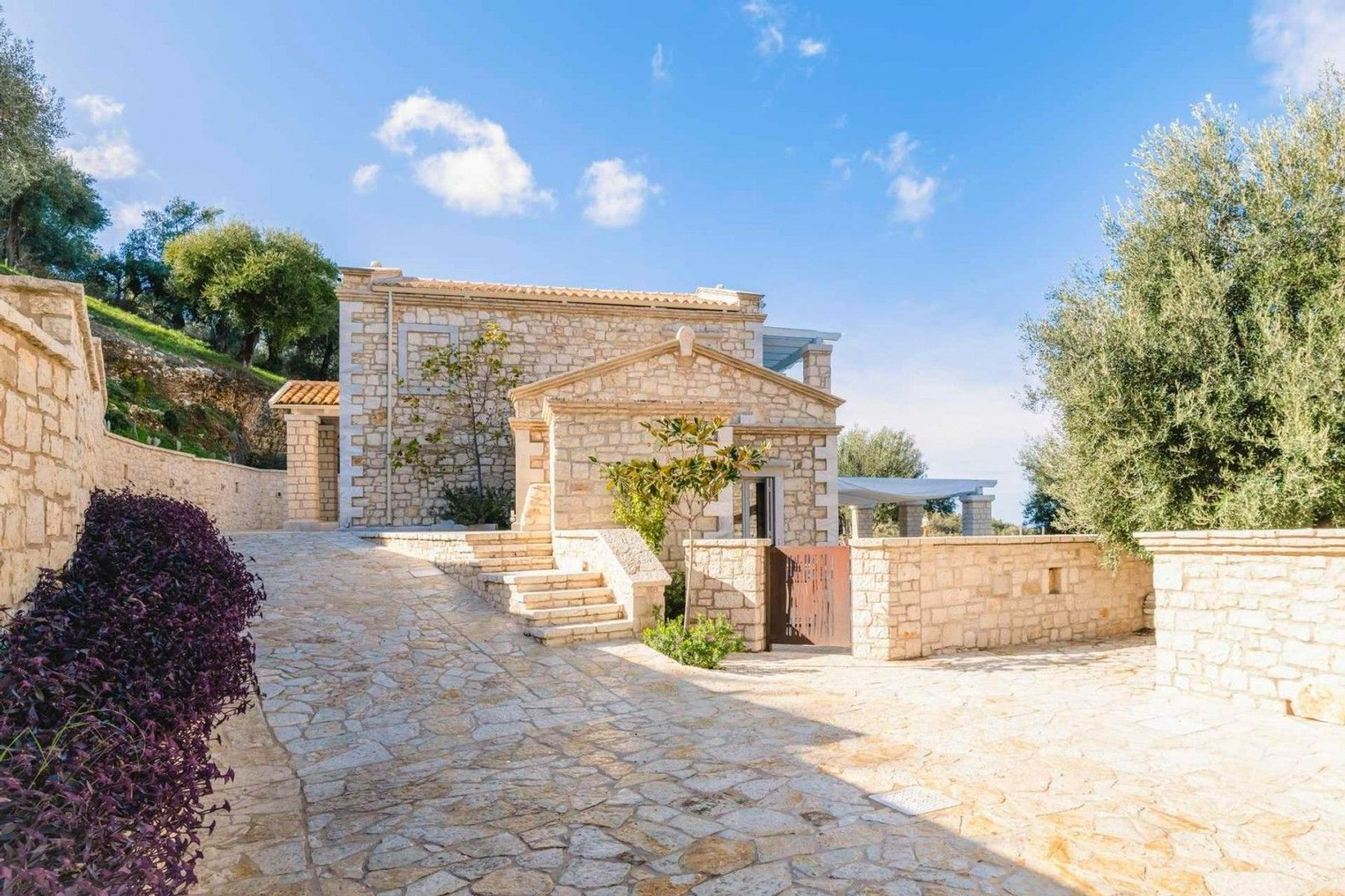 Charming stone-built residence with expansive grounds, lush greenery, and sublime sea views.