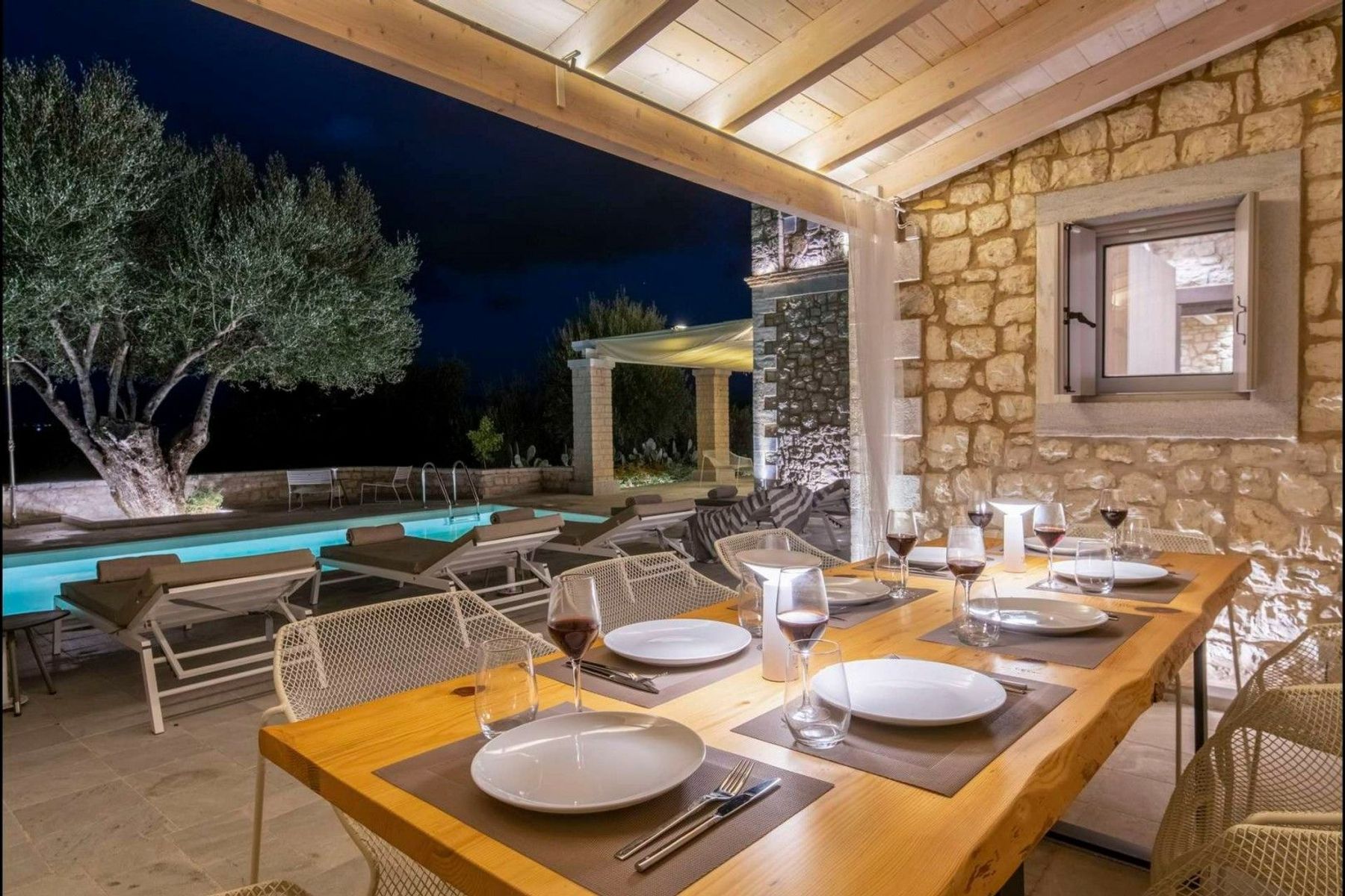 Dine alfresco in the stunning outdoor dining area with a dining table for eight guests, and views overlooking the swimming pool.