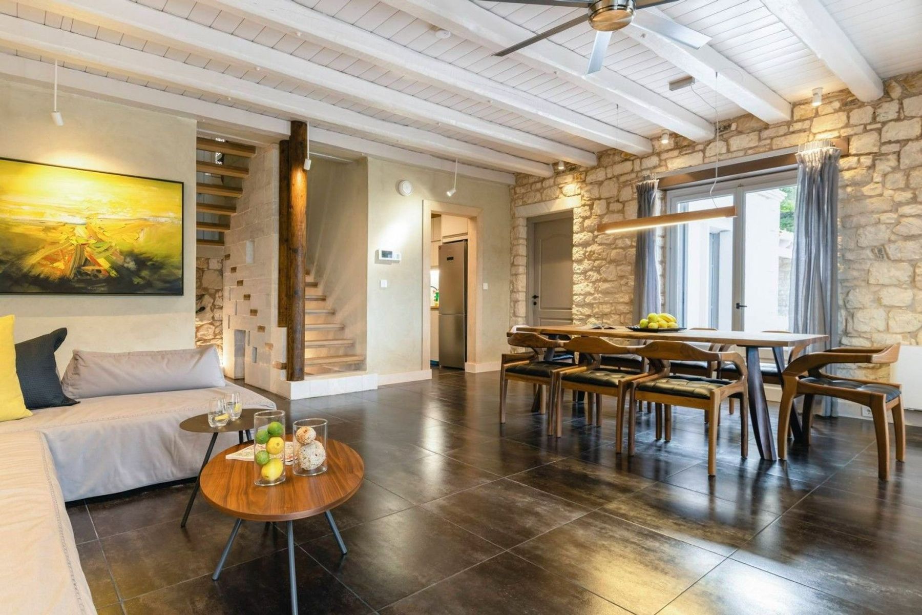 Stunning open-plan living area with dining table that seats up to eight guests.