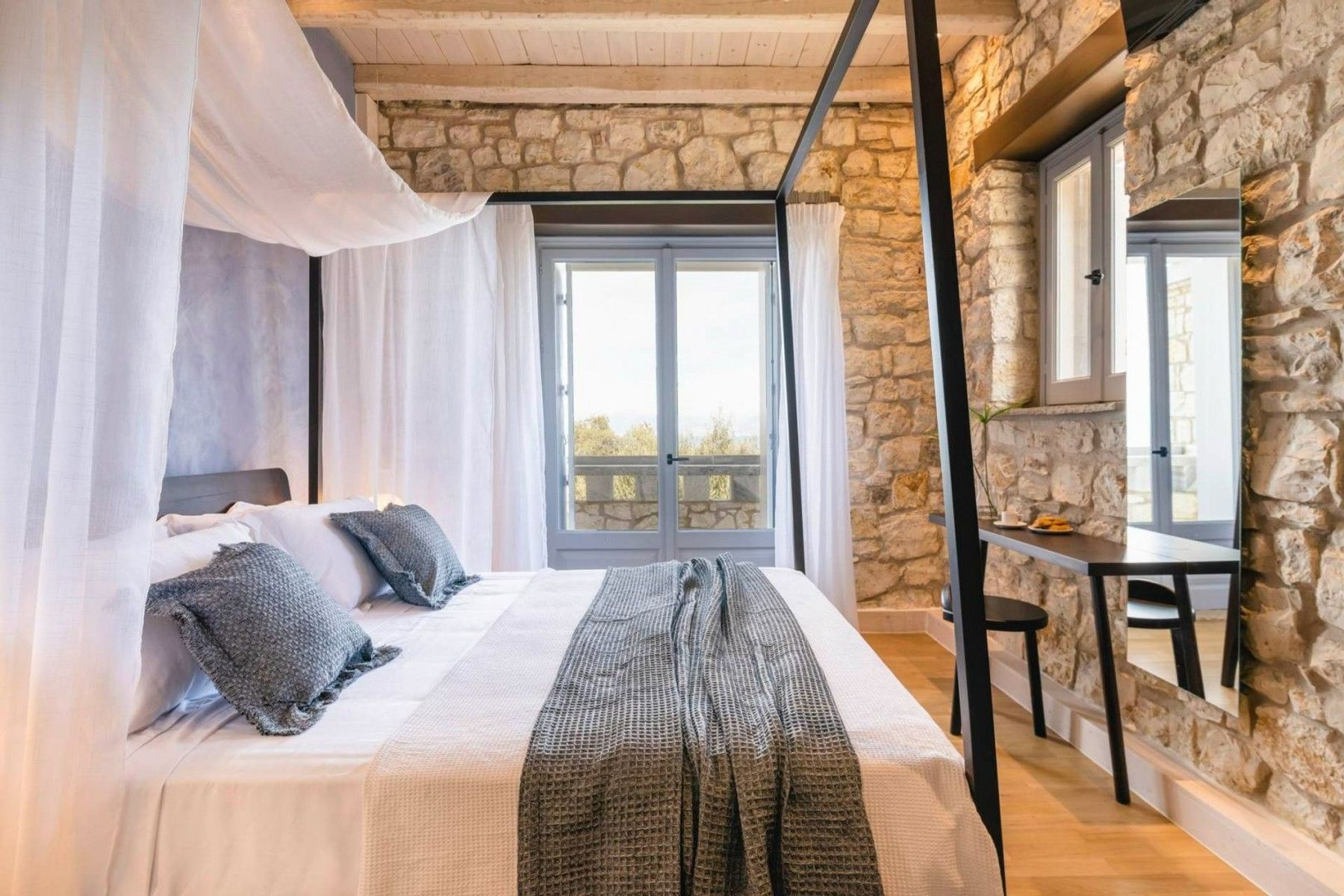 Double ensuite bedroom with access to a balcony with lounge area, and sea views.