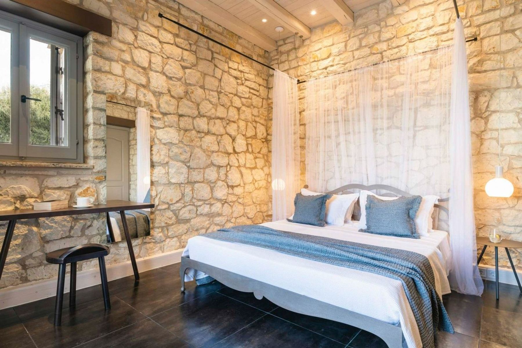 Double ensuite bedroom with plush bedding, and elegant furniture.
