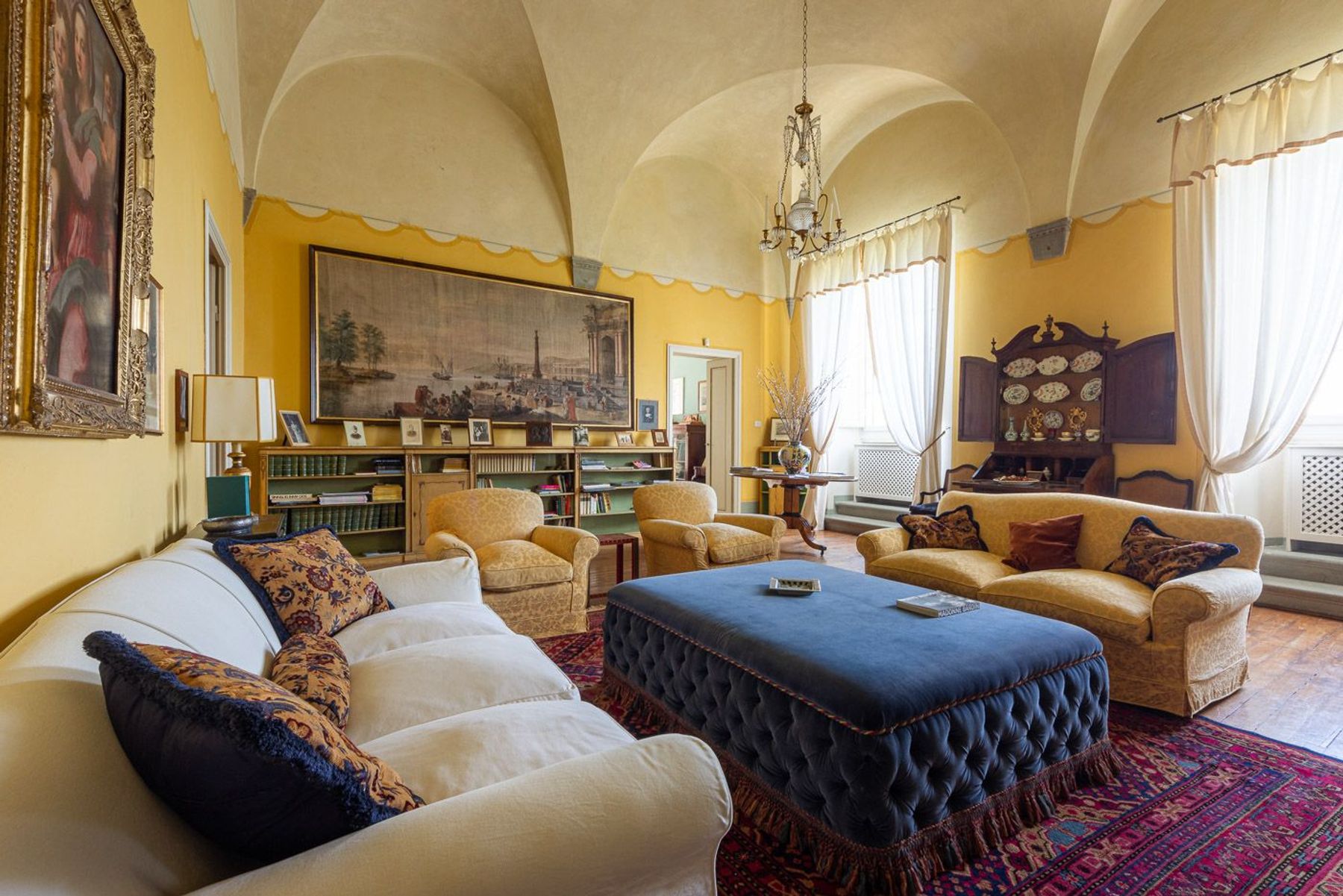 Elegant sitting room with original features aplenty, such as vaulted ceilings and wooden flooring.