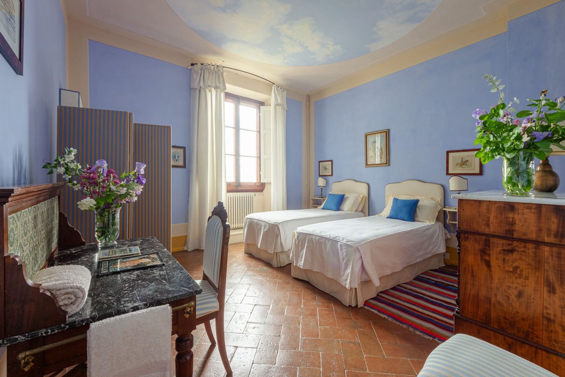 Twin bedroom with air-conditioning and separate desk area.