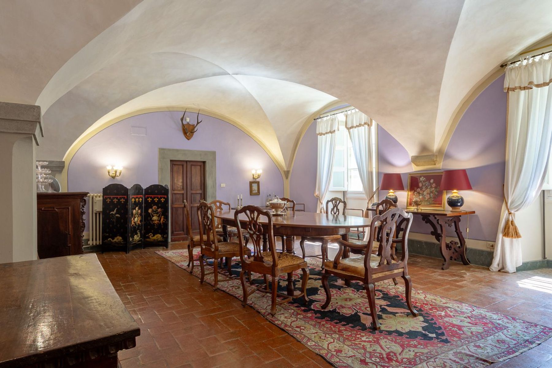 Formal dining room with lavish seating for eight guests, a magnificent room with original vaulted ceilings.