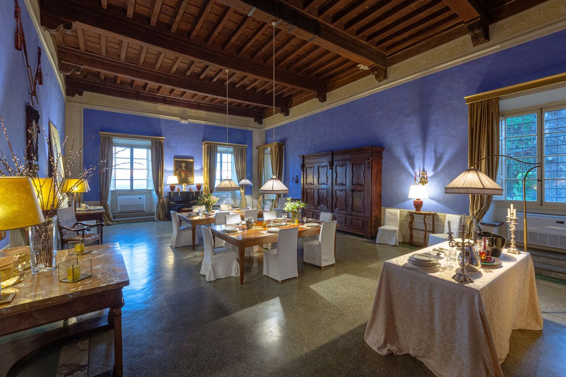 Opulent formal dining room with two separate tables, seating up to six guests each.  
