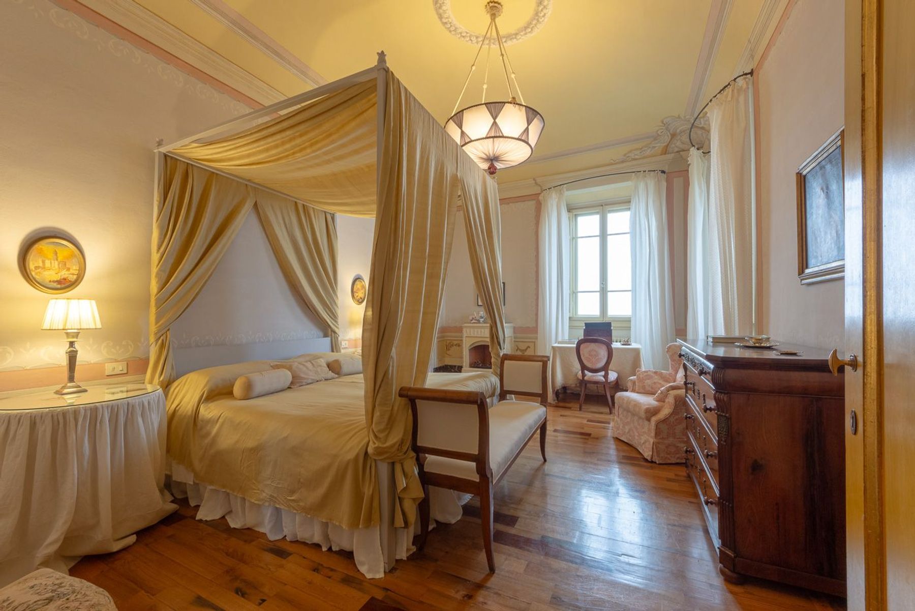 Opulent and grand king ensuite bedroom, with four-poster bed, air-conditioning and original features.