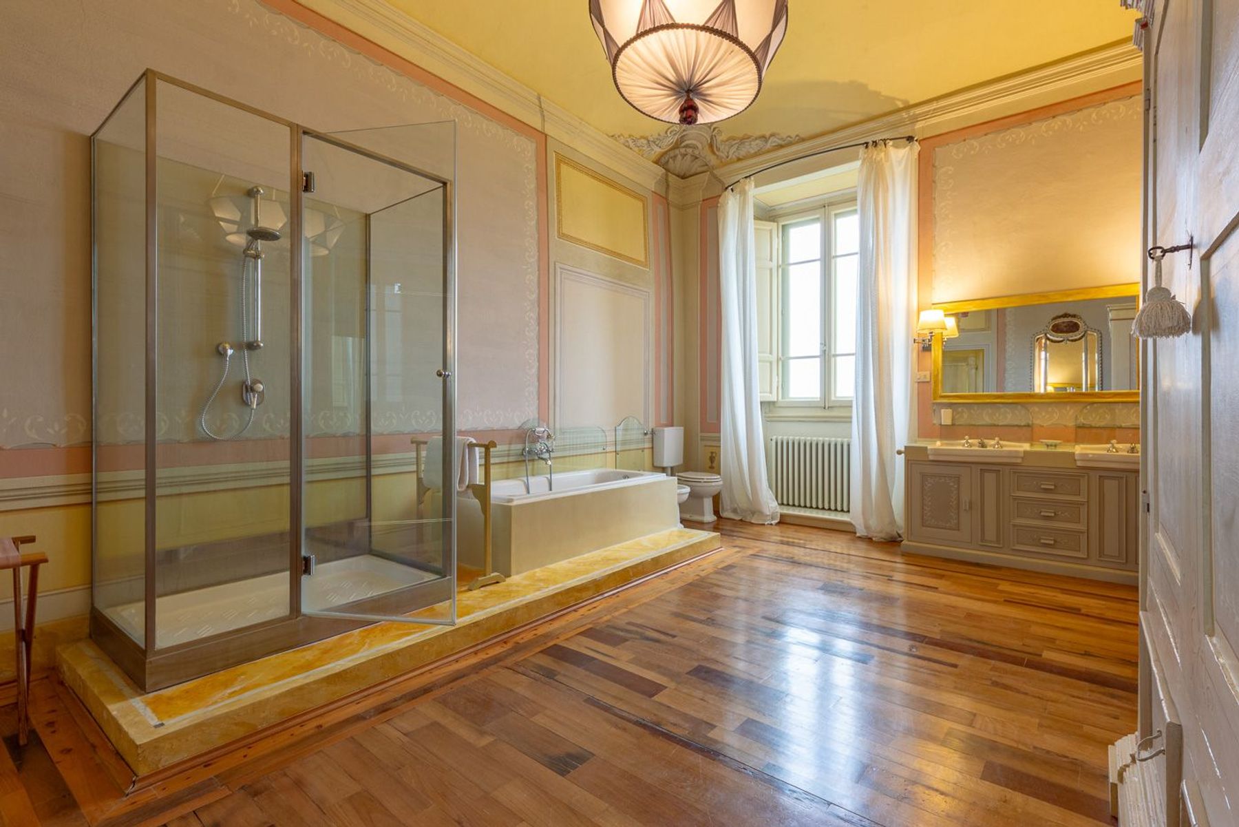Spacious ensuite bathroom with separate walk-in shower, bath-tub and opulent vanity unit. 