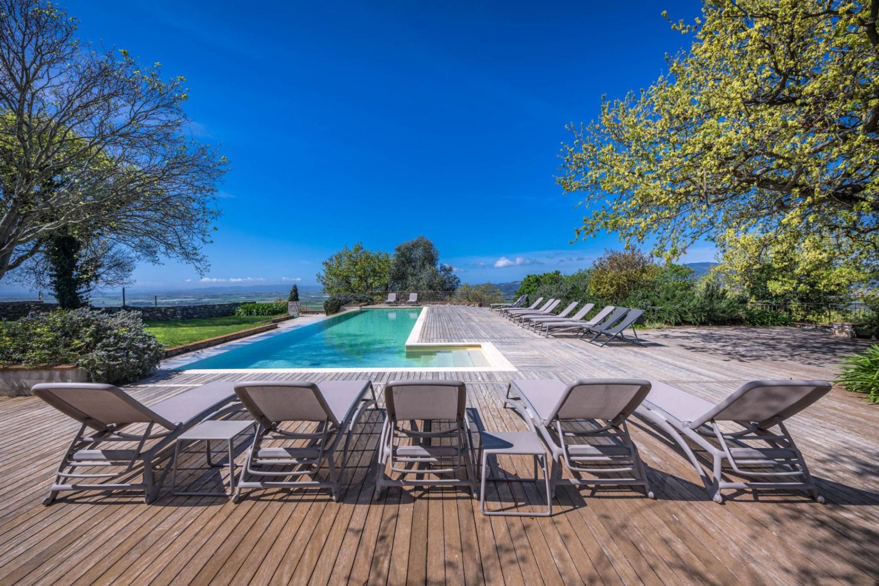 The private infinity pool is complemented by a cascading waterfall, and provides breathtaking vistas of the countryside.