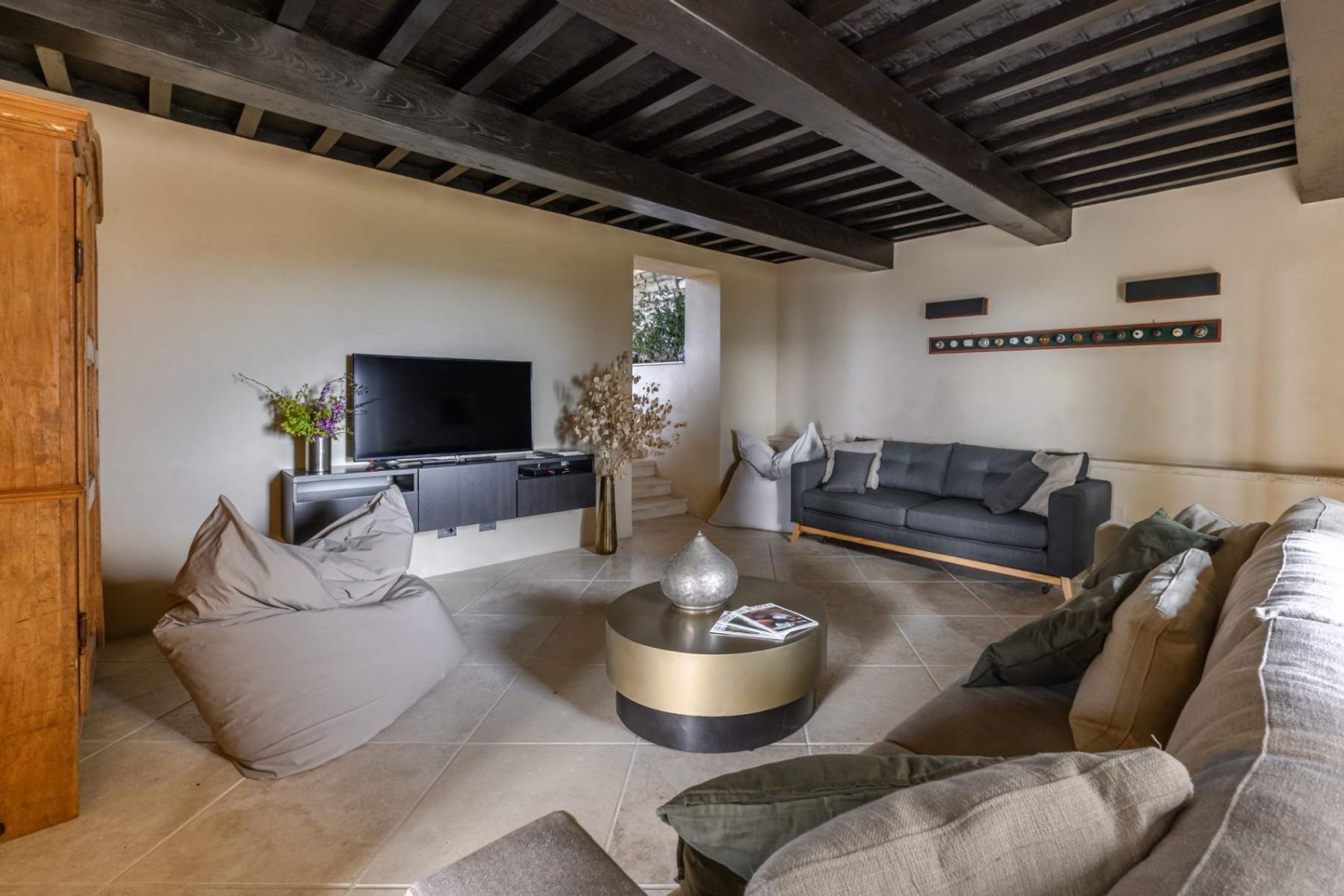 Indulge in the spacious interiors, that features three distinct living rooms for your relaxation. Where original beams contrast against cream walls, evoking timeless elegance. 