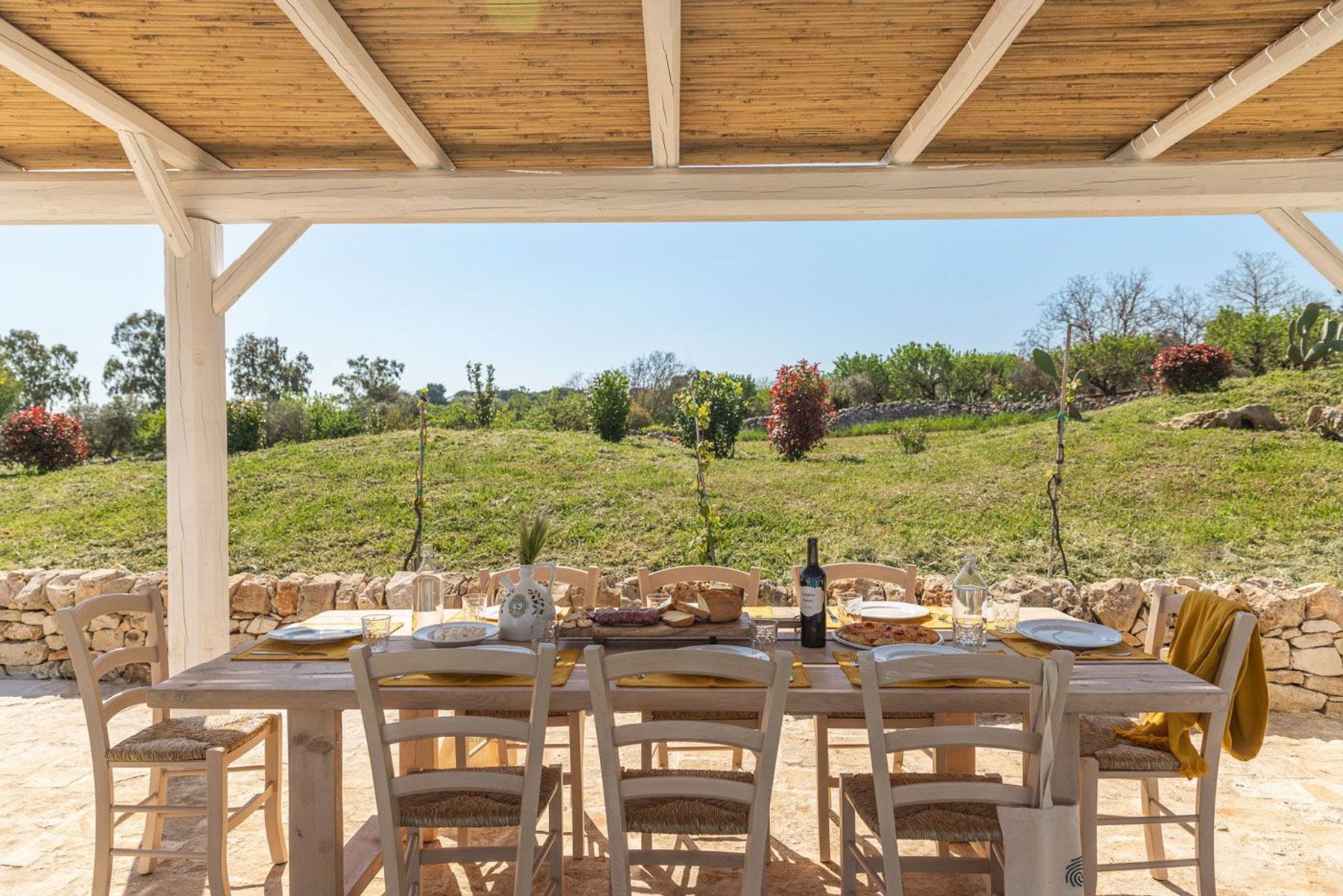 The alfresco dining area has plenty of space for up to eight guests to relax under the shade of a pergola. 