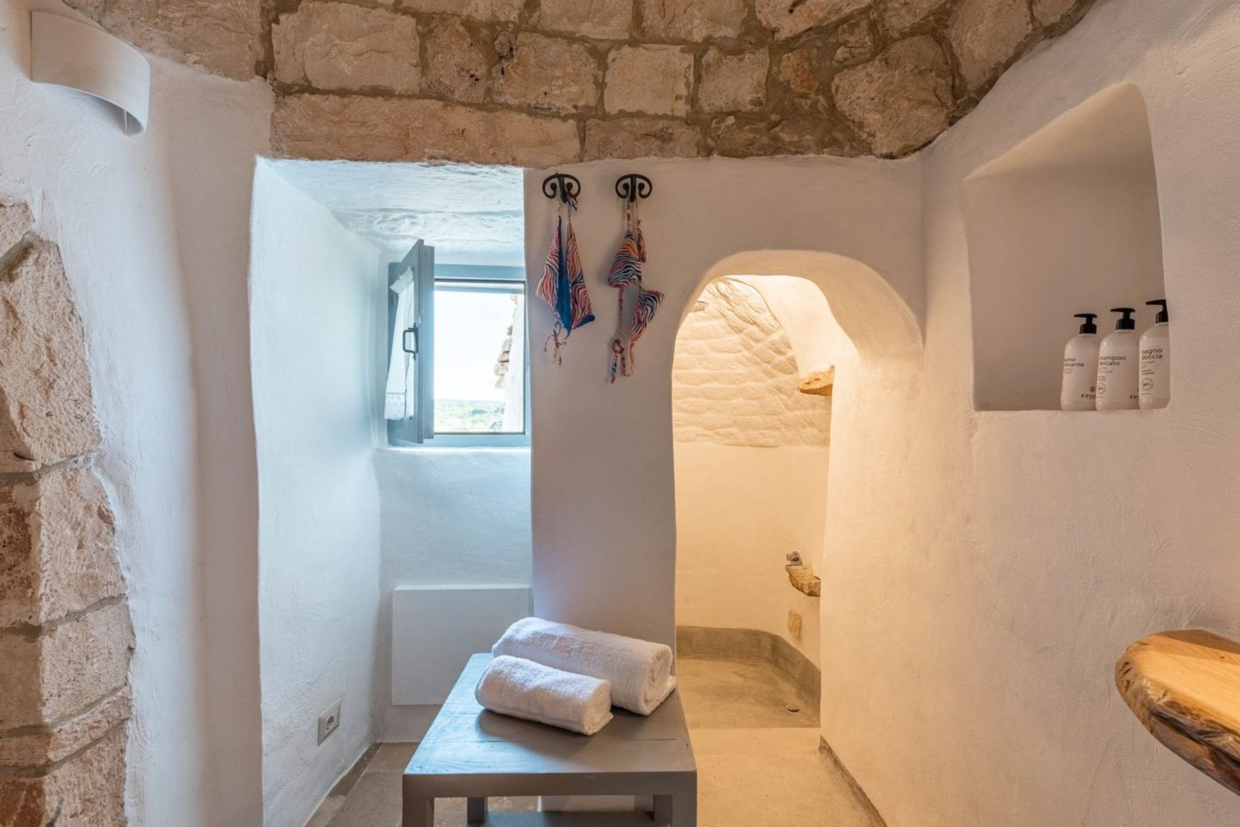 Traditional ensuite bathroom with walk-in shower, toiletries and hairdryer. 