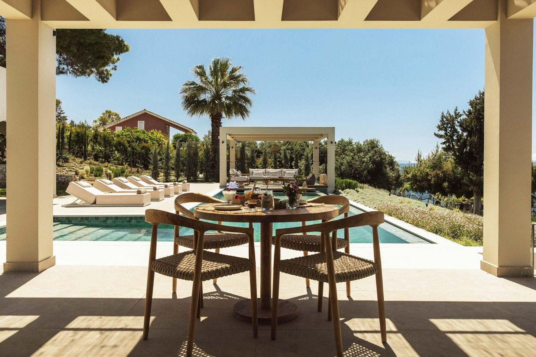Spend long leisurely lunches together under the dining pergola. This dining area features seating for four guests.