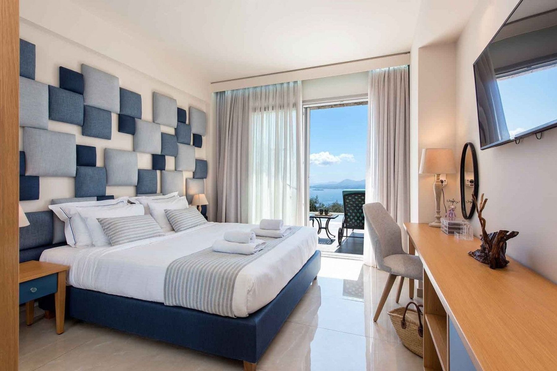 Double ensuite bedroom with air-conditioning, television, and private access to the pool. 