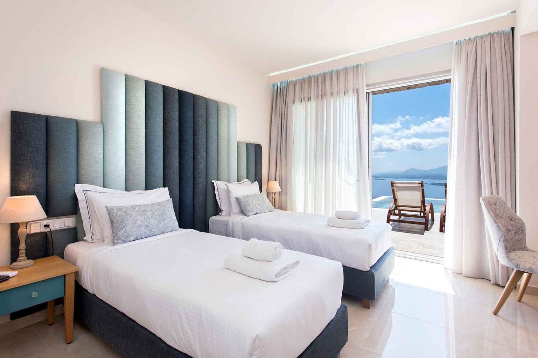 Twin ensuite bedroom with television, and access to the pool. 