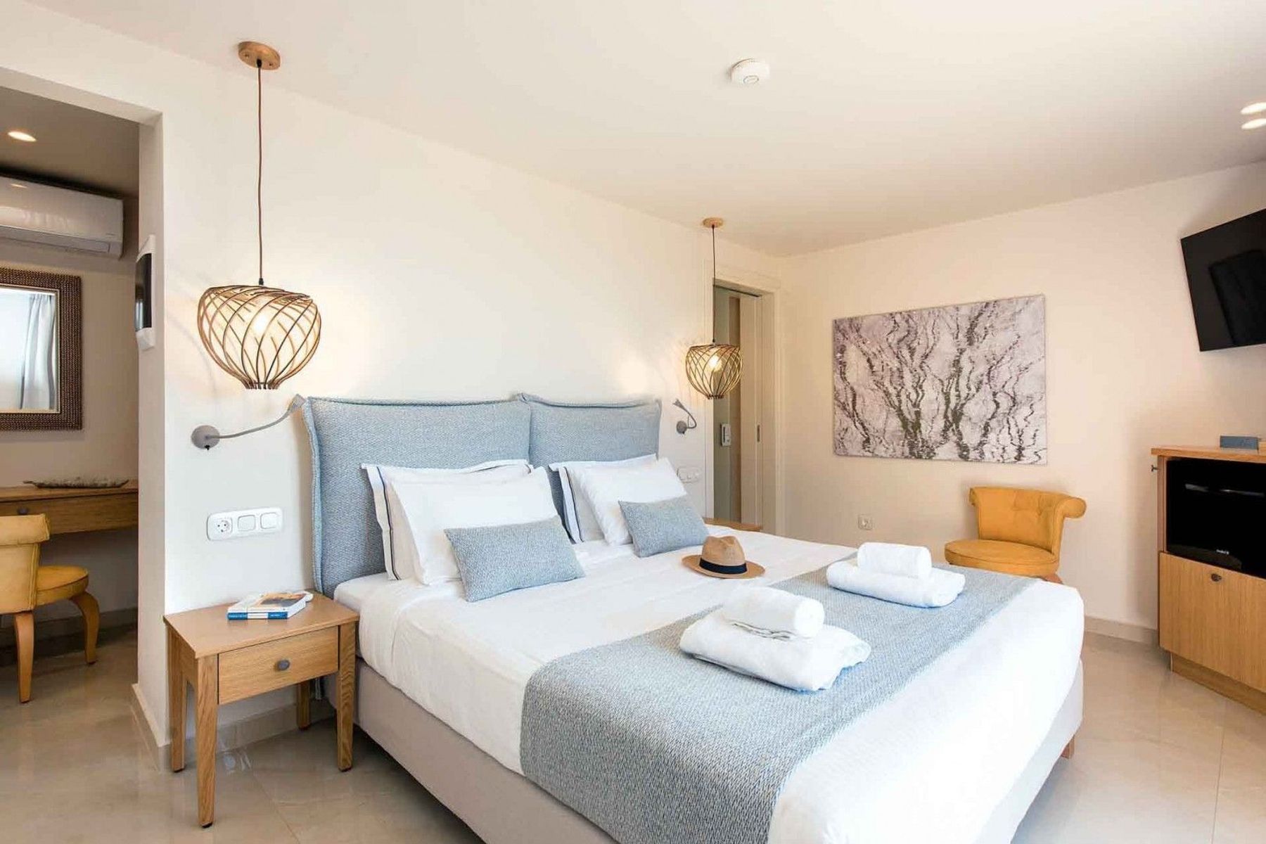 Double ensuite bedroom with king-sized bed, air-conditioning and television.