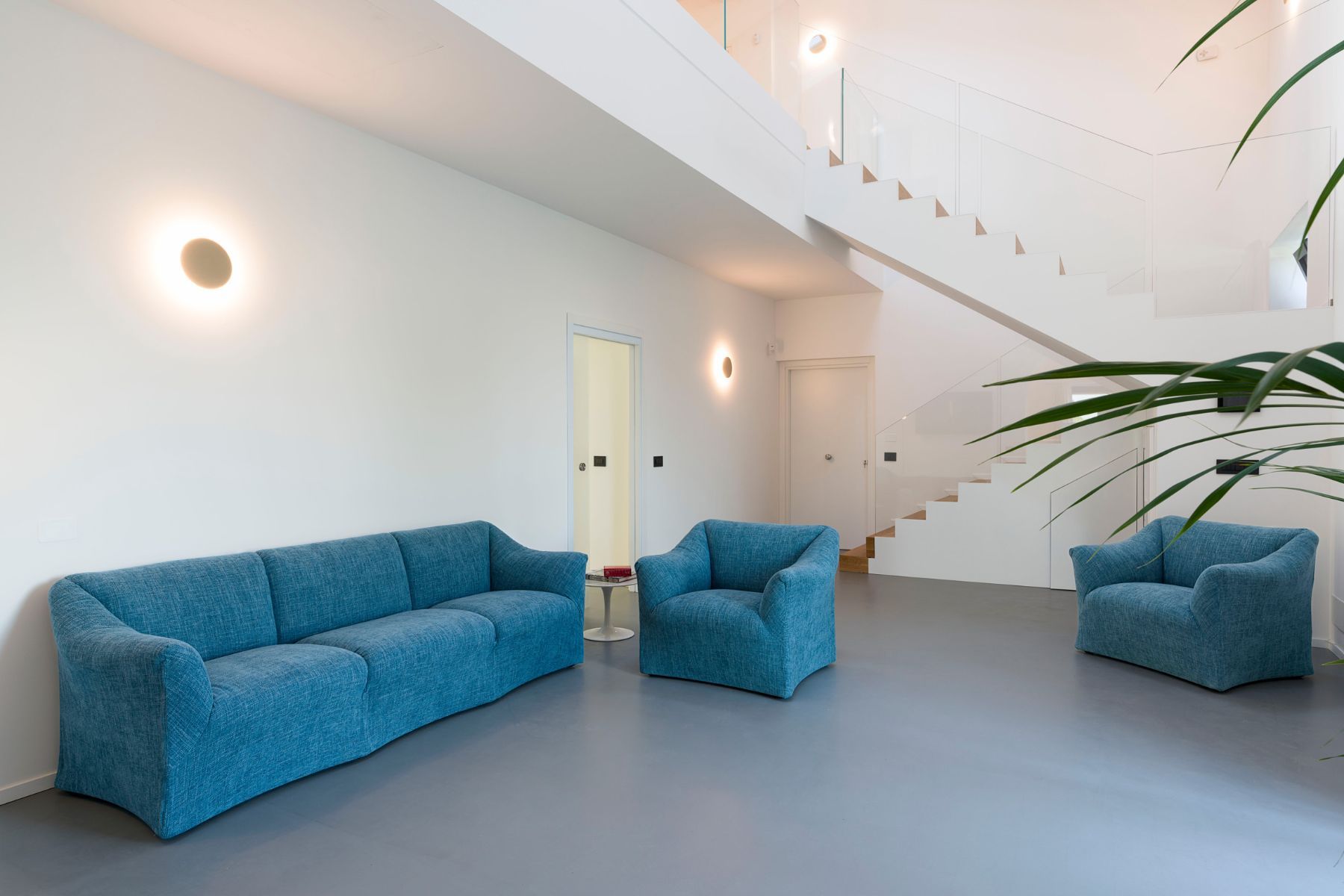 Spacious and bright open-plan living, with comfortable lounge, and television.