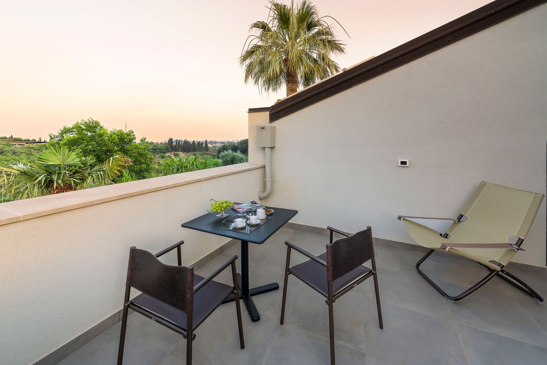 Private terrace with seating area, perfect for admiring the sunset views.