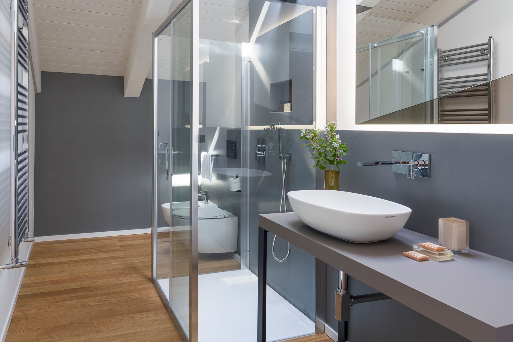 Contemporary ensuite bathroom with walk-in shower, modern sink, and vanity unit.