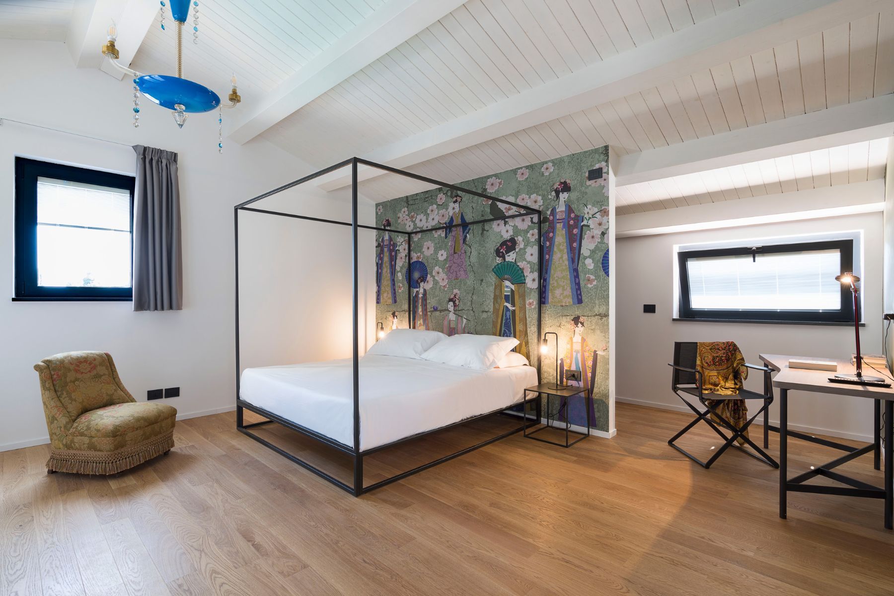 Spacious double bedroom with four-poster bed, and home working desk.