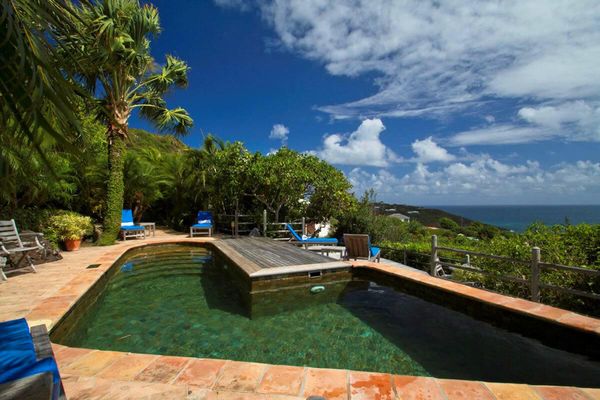 The pool is situated in a beautiful tropical setting at Kyody Villa