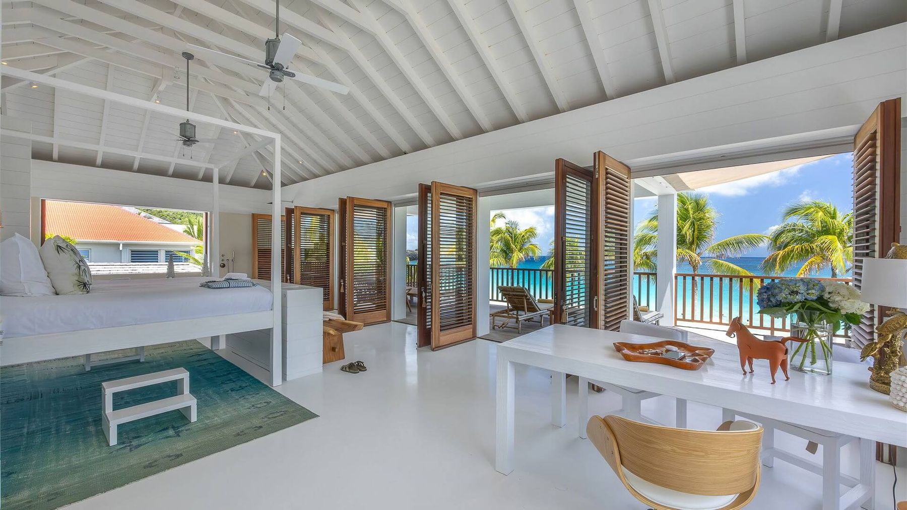 Upper level bedroom with views of the beach and pool