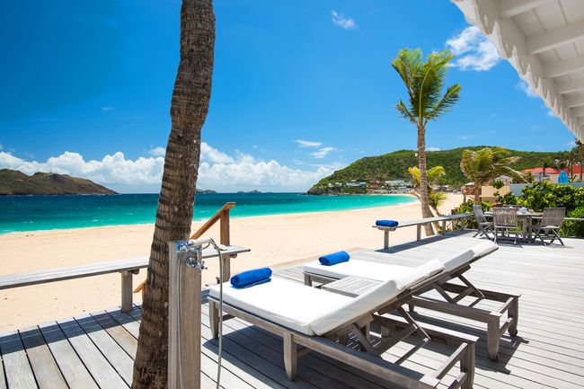 Lounge on the beachfront deck at Fay Villa