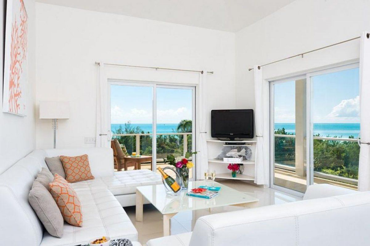 Sliding glass windows open to beautiful ocean views