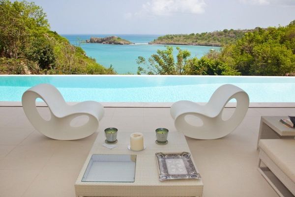 Relax in style by the poolside over looking the Caribbean