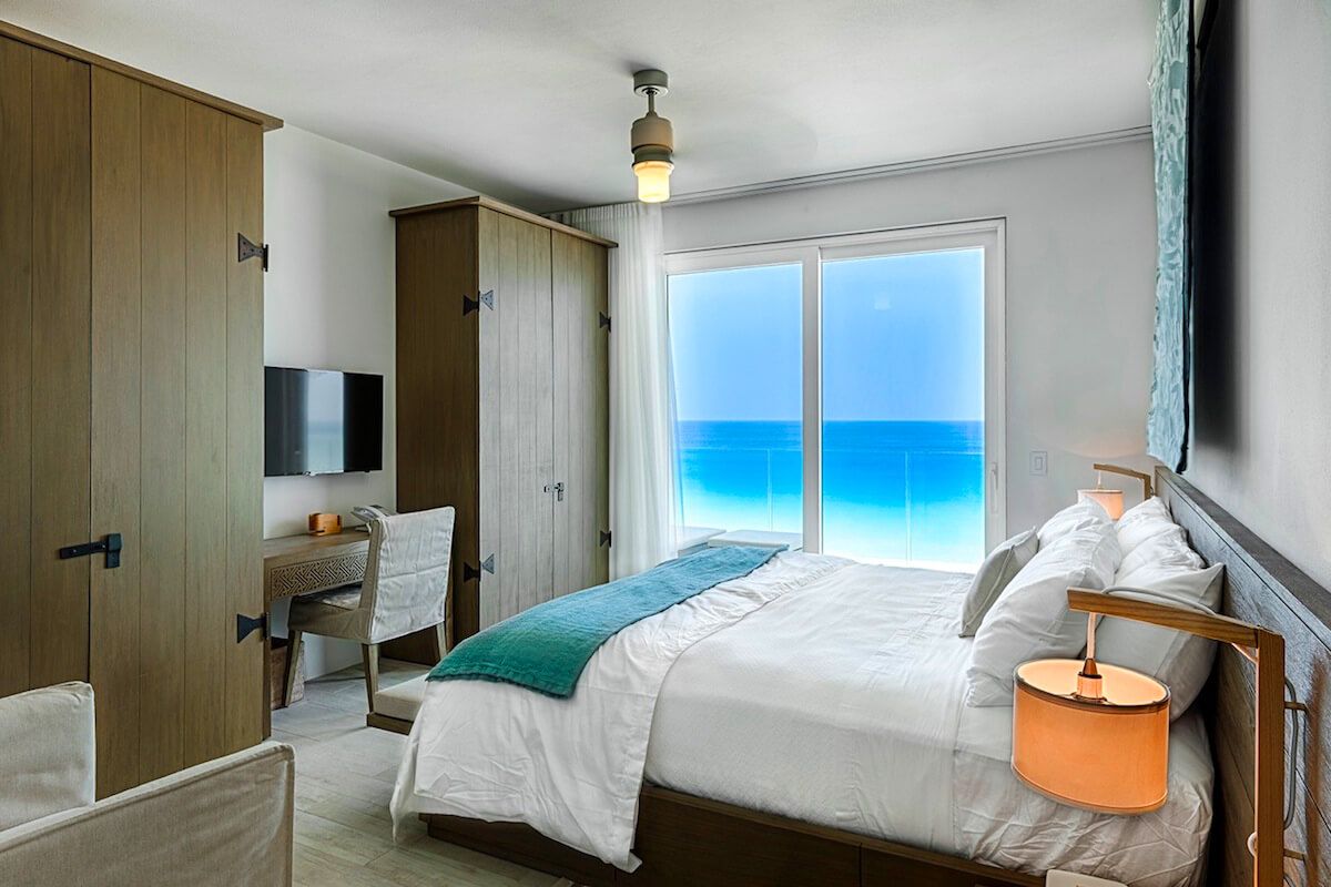Guest bedroom suite has a desk/study and ocean views