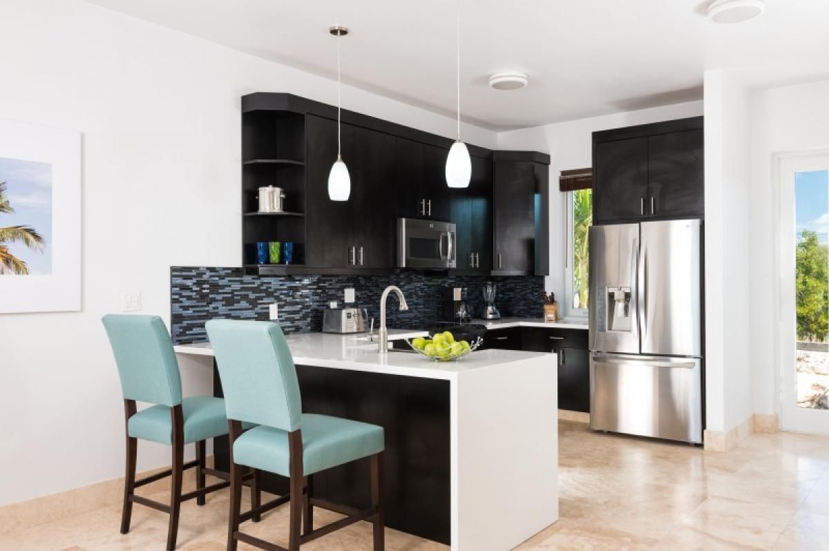 A efficient kitchen with a breakfast bar that seats two
