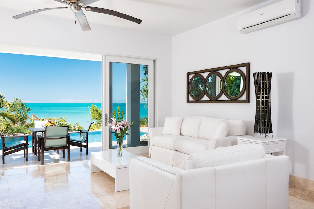 The living area has glass doors that open the the pool patio