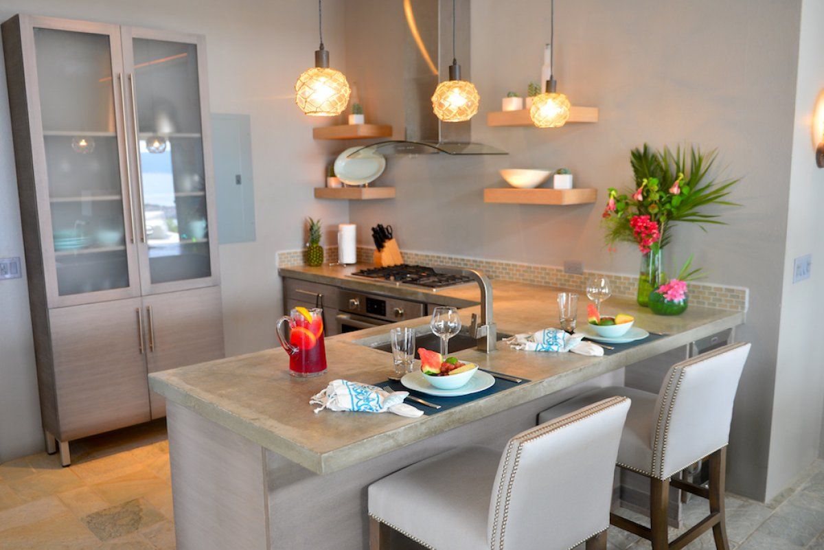 An efficient kitchen with a breakfast bar that seats two people