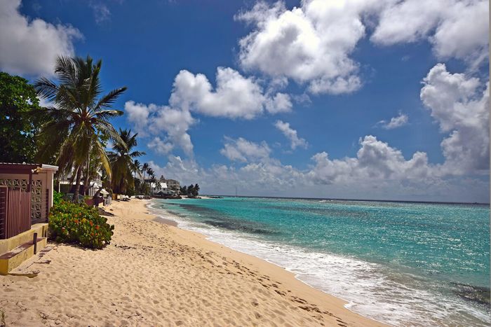 A sandy stretch of beach along the front of Arcadia Villa