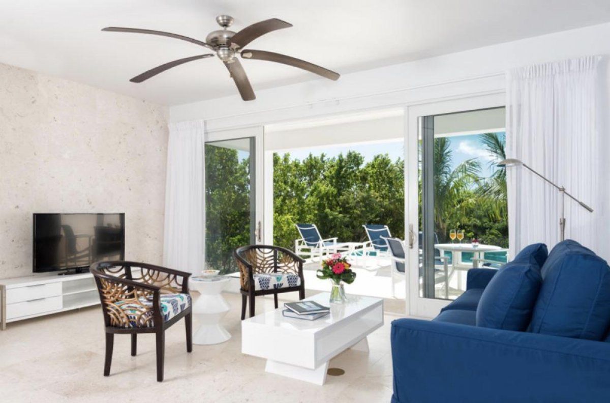 The living area opens to the pool and patio